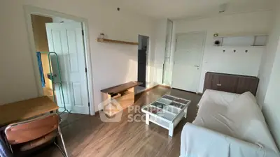 Cozy living room with wooden flooring and modern furniture in a stylish apartment.