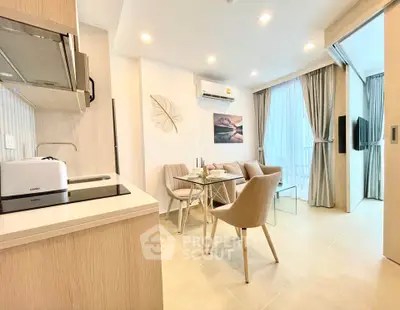 Modern open-plan living room with dining area and kitchen in bright apartment
