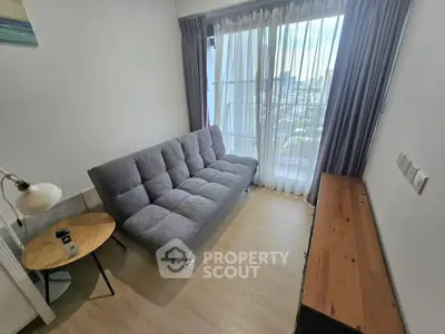 Cozy living room with modern sofa and city view through large window