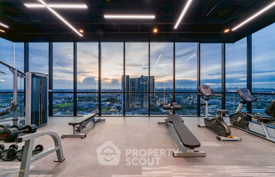 Modern gym with panoramic city view and state-of-the-art equipment.