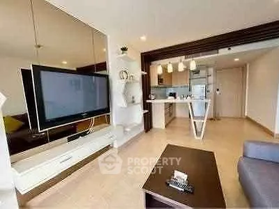 Modern living room with open kitchen and stylish decor in a contemporary apartment.