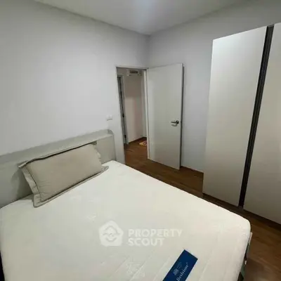 Cozy bedroom with modern wardrobe and comfortable bed in a stylish apartment.