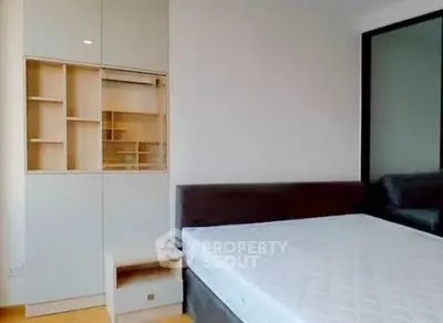 Modern bedroom with sleek built-in storage and comfortable bed