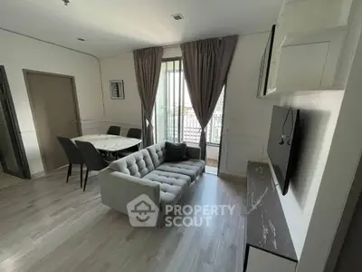 Modern living room with stylish furniture and balcony view