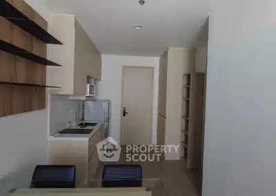 Modern kitchen with sleek cabinetry and integrated appliances in a compact layout.