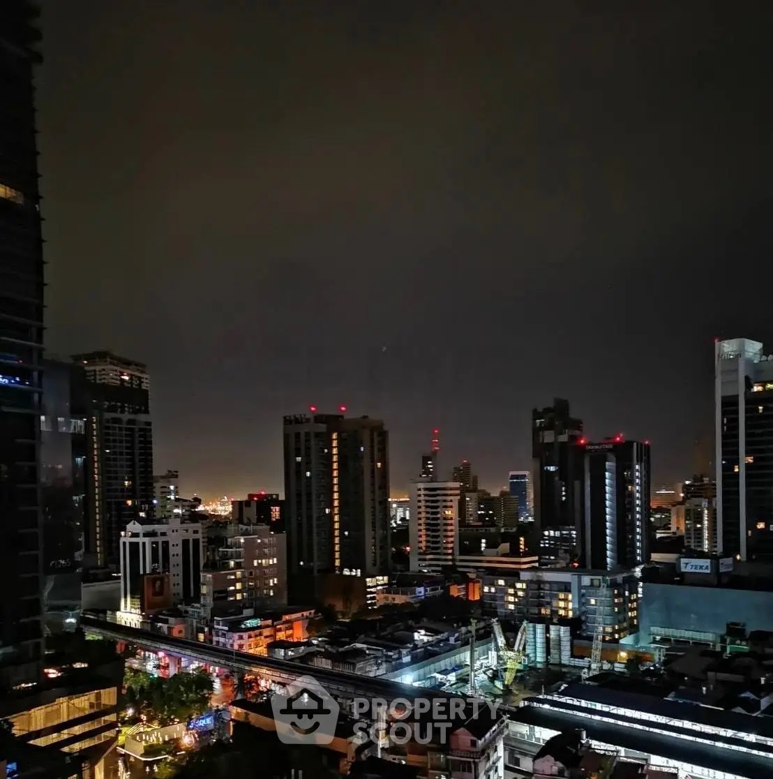 Stunning nighttime cityscape view showcasing vibrant urban skyline and illuminated buildings.