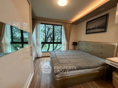 Luxurious bedroom with large window and elegant decor in modern apartment