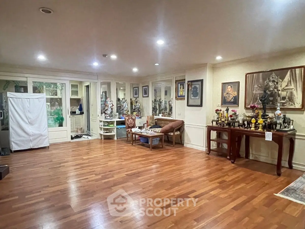 Spacious living room with hardwood floors and elegant decor