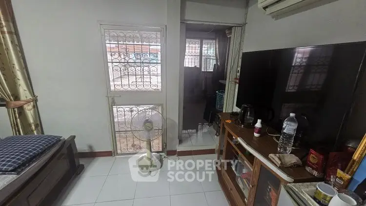 Cozy interior with TV, fan, and air conditioning in a compact living space.