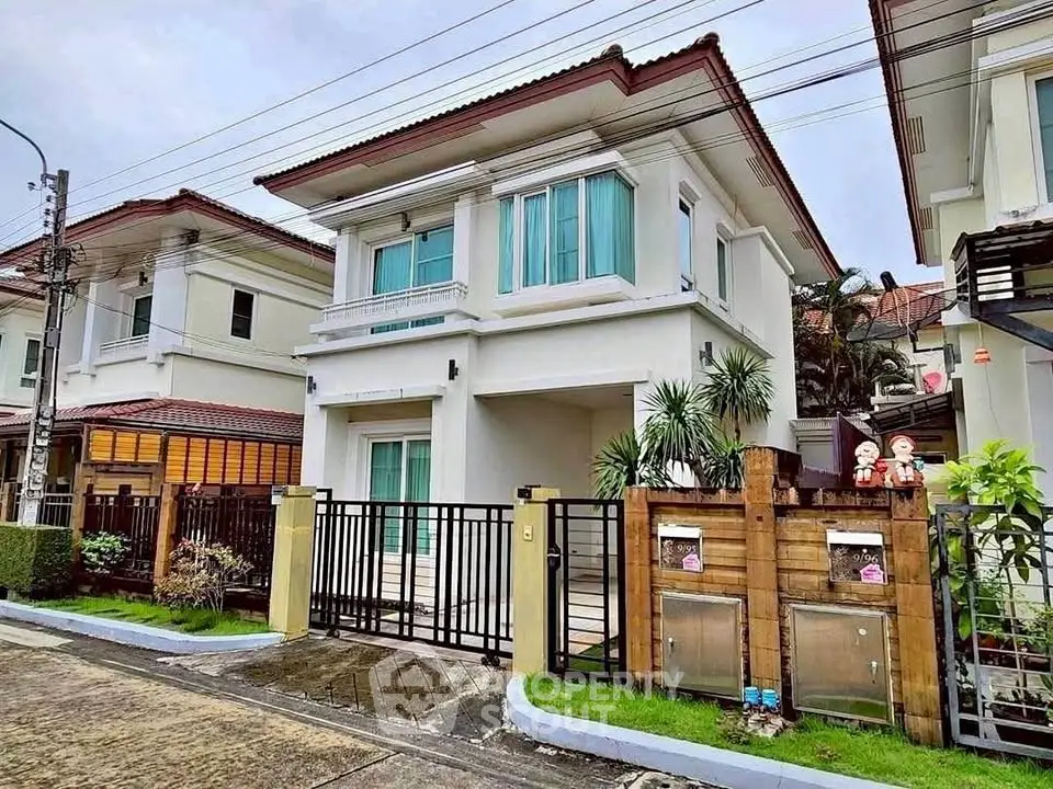 Charming two-story house with modern design and lush landscaping in a serene neighborhood.