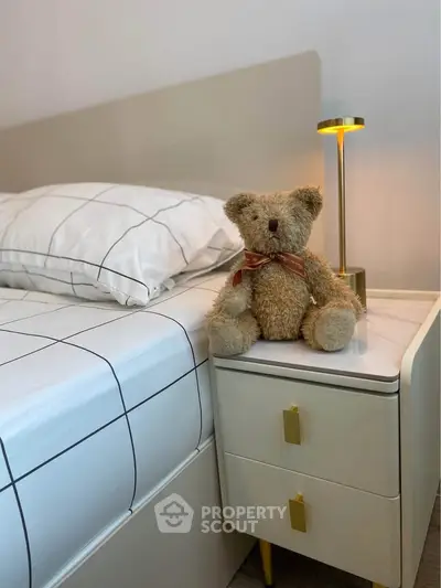 Cozy bedroom with stylish nightstand and teddy bear decor