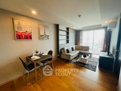 Modern living room with city view, stylish decor, and cozy dining area in a high-rise apartment.