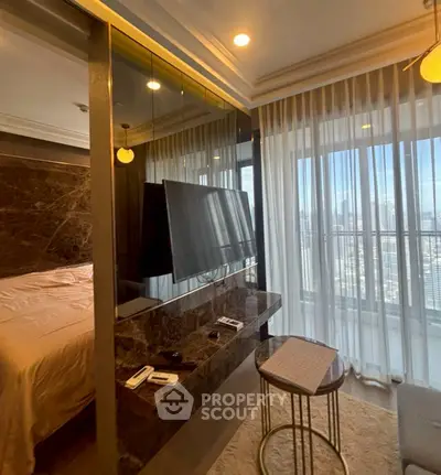 Luxurious bedroom with city view, featuring modern decor and large windows for natural light.