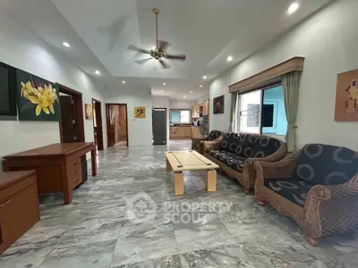 Spacious living room with elegant decor and marble flooring in a modern home