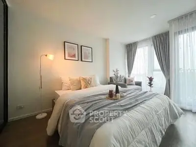 Elegant bedroom with cozy decor and natural light, featuring a stylish bed and modern furnishings.