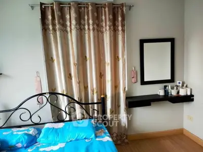 Cozy bedroom with elegant curtains and stylish mirror, perfect for relaxation.