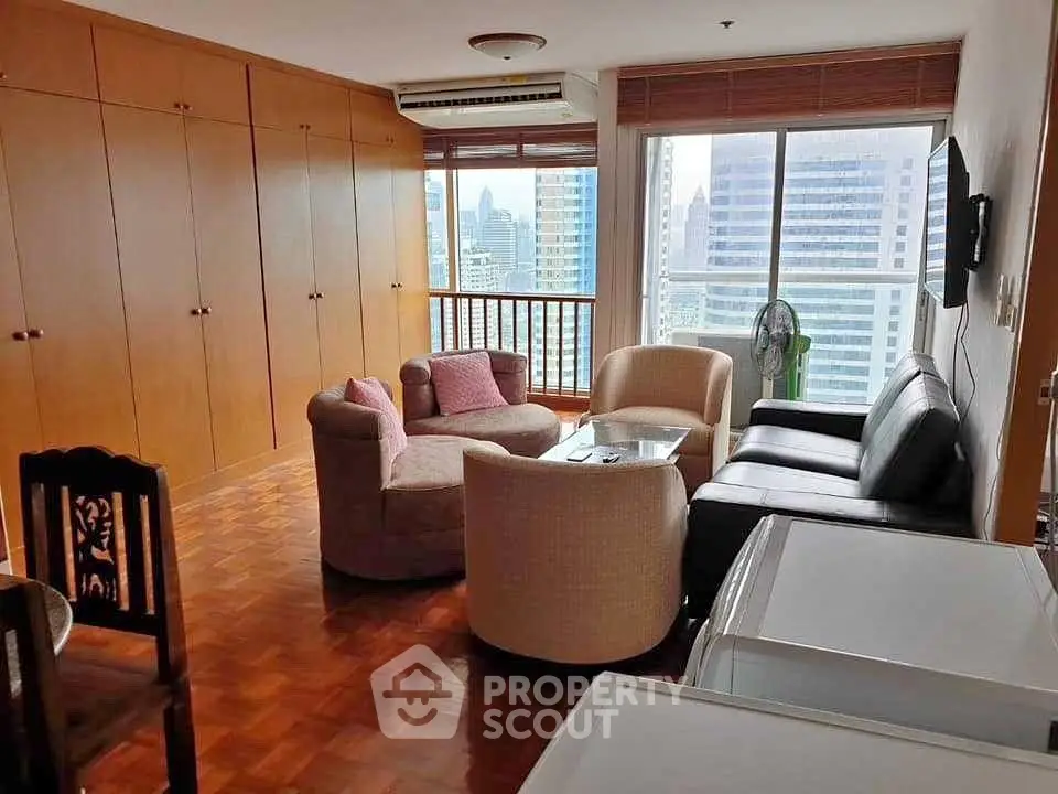 Spacious living room with city view, cozy seating, and wooden accents in a high-rise apartment.