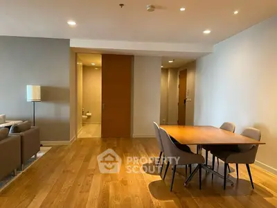Spacious modern living room with wooden flooring and elegant dining area