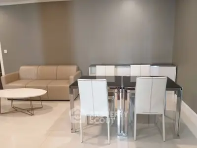 Modern living room with sleek dining set and beige sofa, perfect for stylish urban living.
