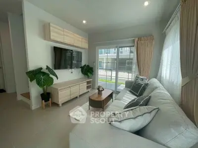 Modern living room with large windows and stylish decor in a contemporary home.