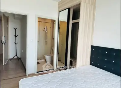 Modern bedroom with ensuite bathroom and stylish wardrobe in a contemporary apartment.