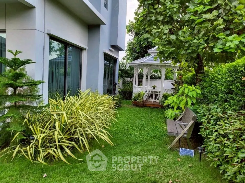 Charming garden with lush greenery and a cozy gazebo, perfect for relaxation and outdoor gatherings.