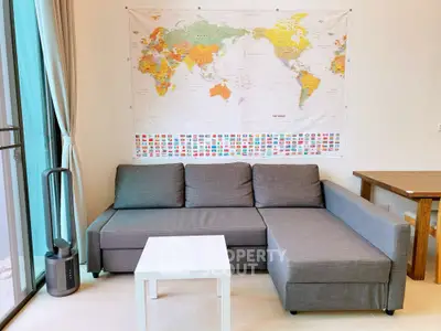 Modern living room with gray sectional sofa and world map decor