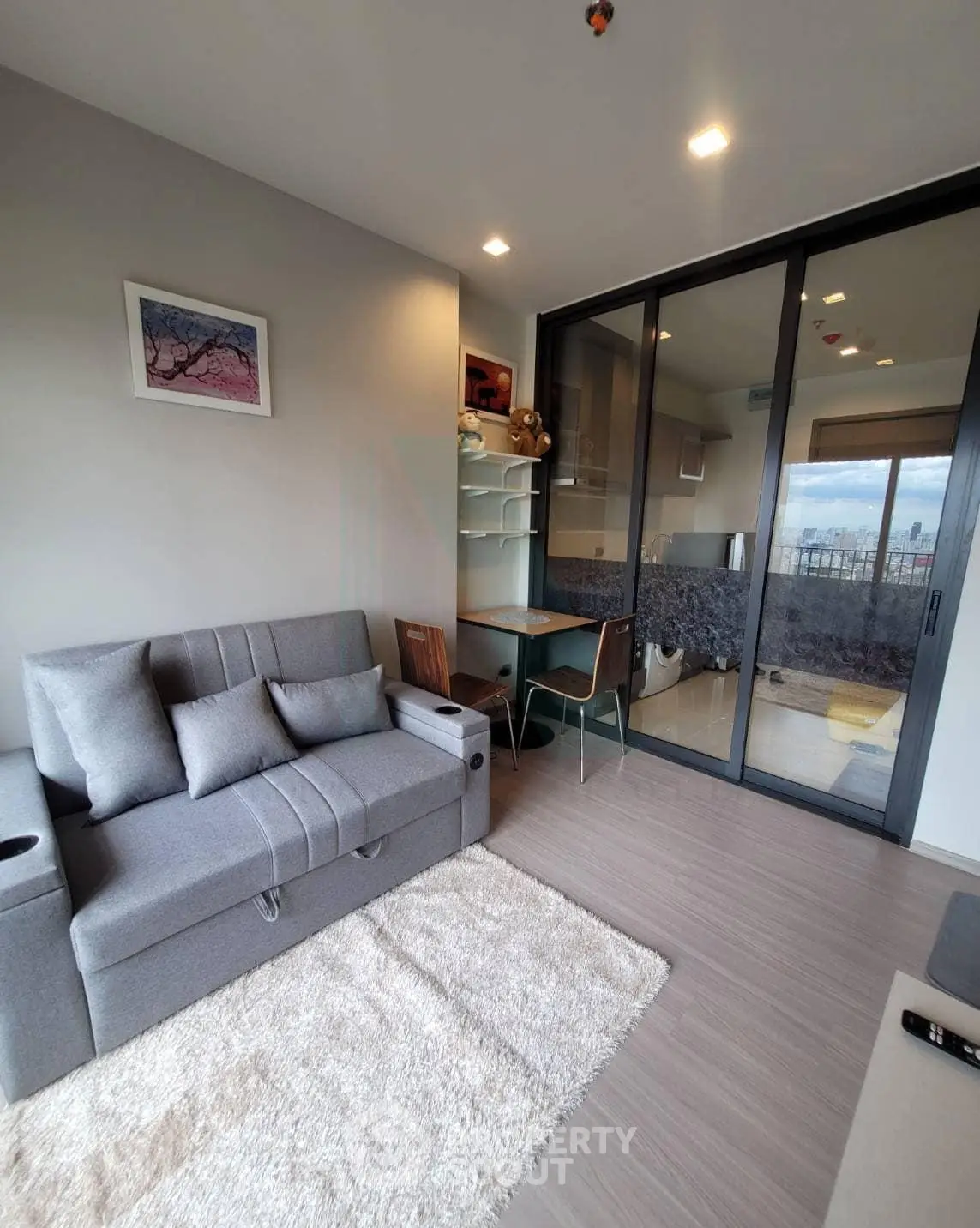 Modern living room with cozy sofa and balcony view in stylish apartment