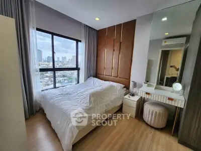 Luxurious bedroom with city view, elegant decor, and modern furnishings in a high-rise apartment.