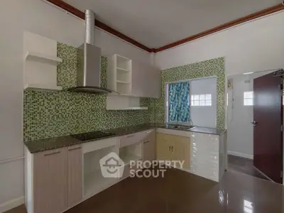 Modern kitchen with stylish mosaic backsplash and sleek cabinetry