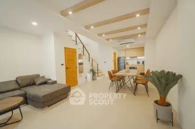 Spacious modern living room with open kitchen and stylish decor