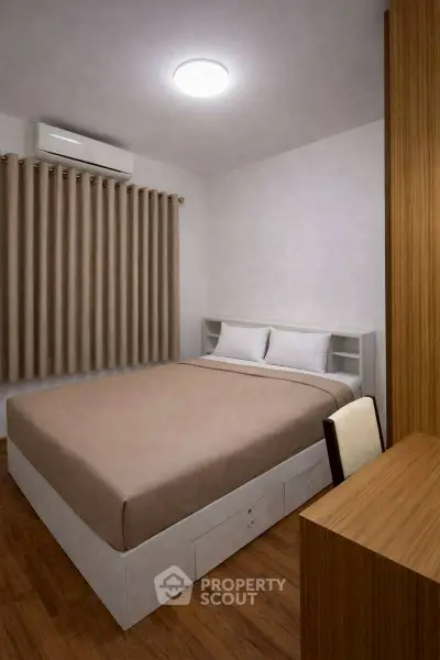 Cozy bedroom with modern design and wooden accents, featuring a comfortable bed and ample storage.