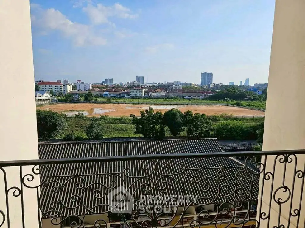 Scenic balcony view overlooking cityscape and greenery, perfect for urban living.