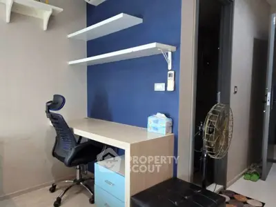 Modern study area with desk, chair, and shelves in stylish apartment.