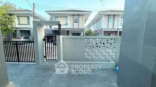 Modern residential neighborhood with stylish townhouses and sleek exterior design.