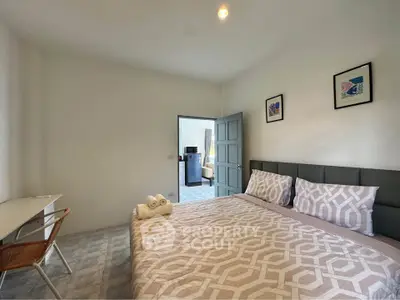 Spacious bedroom with modern decor and cozy ambiance