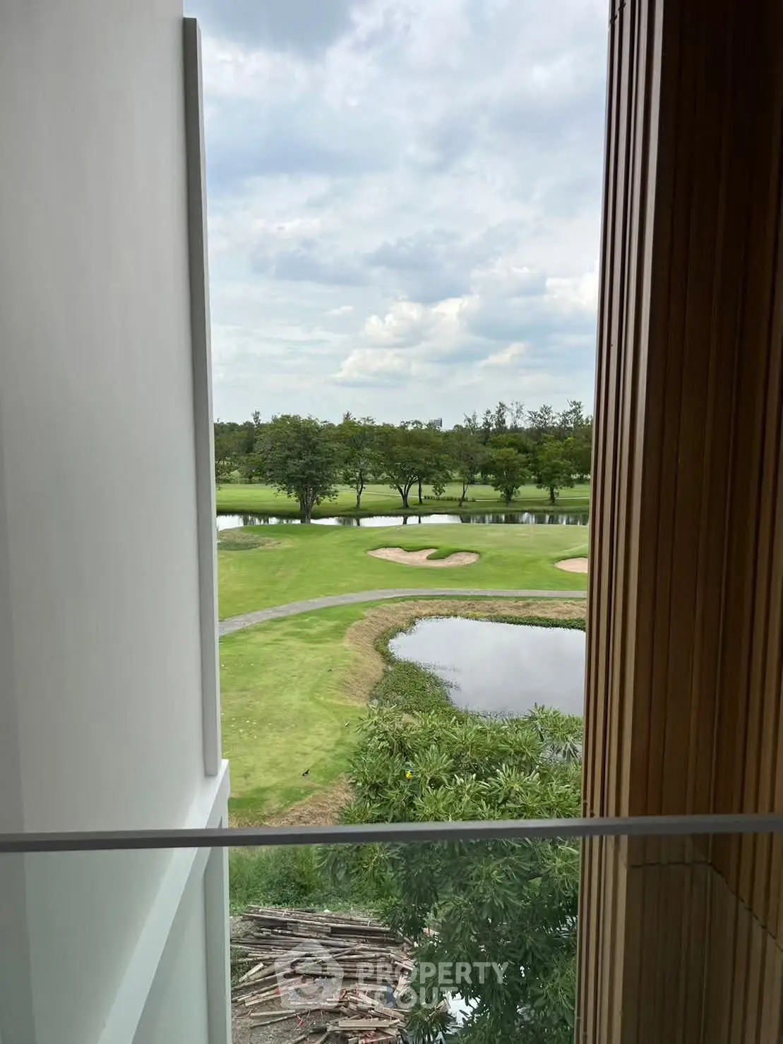 Stunning golf course view from modern balcony, perfect for relaxation and leisure.