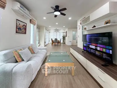 Spacious modern living room with stylish decor and entertainment setup