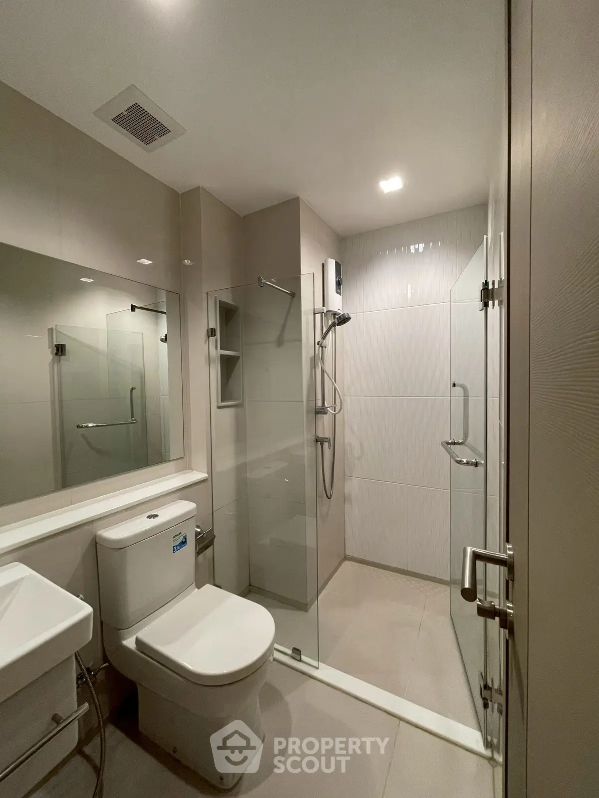 Modern bathroom with glass shower and sleek fixtures in a contemporary apartment.