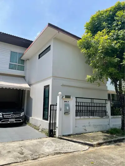 Charming modern townhouse with carport and lush tree in front yard