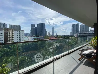 Spacious balcony with stunning city skyline view and lush greenery