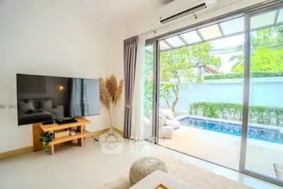 Bright living room with pool view and modern decor