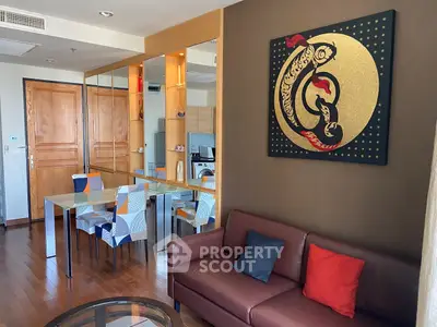 Stylish living room with modern decor and dining area in a contemporary apartment.