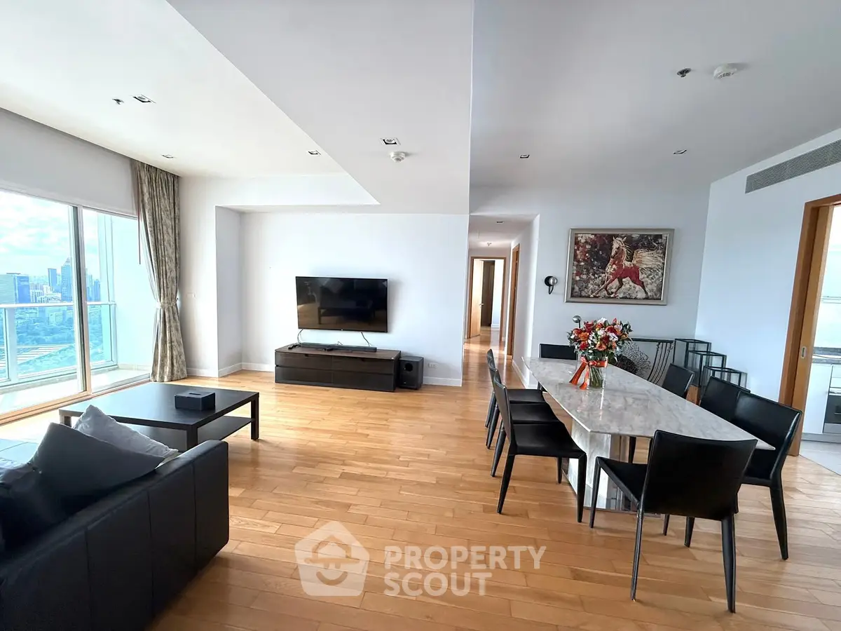 Spacious modern living room with dining area and city view, perfect for urban living.
