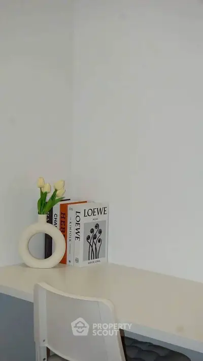 Minimalist study nook with modern decor and white furniture, perfect for a serene workspace.