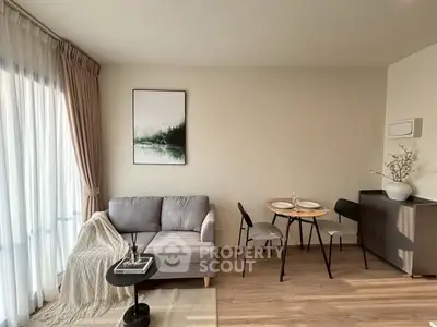Modern living room with cozy sofa, elegant dining area, and natural light from large windows.