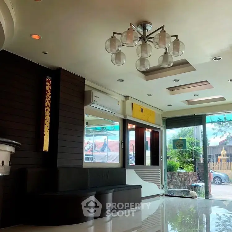 Modern living room with stylish lighting and large windows for natural light.