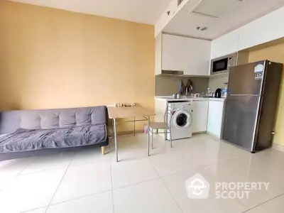 Modern compact kitchen with washing machine and fridge in cozy apartment