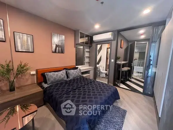 Modern bedroom with stylish decor and ensuite bathroom in a contemporary apartment.