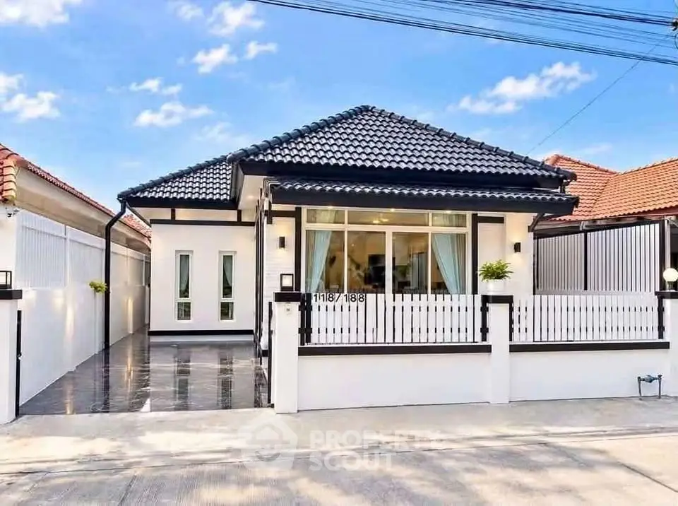 Charming single-story house with modern design and spacious driveway in a serene neighborhood.